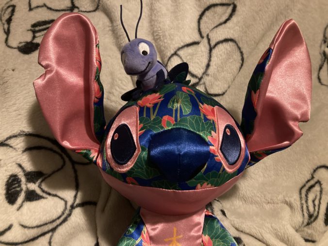 Close up of plushie featuring Cricket on Stitch's head